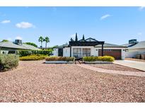Charming single-story home featuring a pergola, brick accents, and well-maintained landscaping at 13207 N 55Th Ave, Glendale, AZ 85304