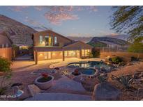 Inviting backyard featuring a beautiful pool, spa, and desert landscaping with patio and views at 14056 E Desert Cove Ave, Scottsdale, AZ 85259