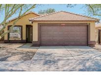 Charming single-story home with neutral stucco, tiled roof, and a two-car garage at 15701 N Bonow Dr, Surprise, AZ 85374