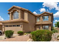 Two-story home featuring a tile roof, desert landscaping, and an attached two-car garage at 16823 S 24Th Pl, Phoenix, AZ 85048