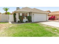 Charming single-story home featuring a well-maintained lawn and a two-car garage, enhancing curb appeal at 18219 N 19Th St, Phoenix, AZ 85022
