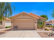 Charming single-story home features a terracotta tile roof, low maintenance desert landscaping, and a two car garage at 2015 E Glenhaven Dr, Phoenix, AZ 85048