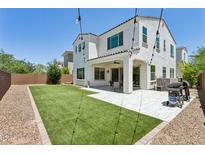 Expansive backyard features well maintained artificial turf, gravel, and a covered patio, perfect for outdoor entertaining at 22306 N 34Th Pl, Phoenix, AZ 85050