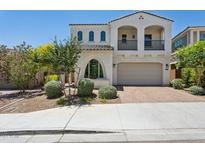 Charming two-story home featuring a balcony, arched windows, and a well-maintained front yard at 22306 N 34Th Pl, Phoenix, AZ 85050