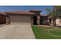Charming single-story home with a well-maintained lawn and desert landscaping at 25862 W North Star Pl, Buckeye, AZ 85326