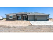 Beautiful single-Gathering home featuring a spacious 3-car garage and a desert landscape in a serene setting at 30639 N Dorado Ct, Queen Creek, AZ 85144