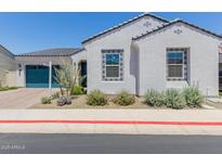 Charming single-story home featuring a blue garage door and decorative tile accents around the windows at 3852 E Bartlett Way, Chandler, AZ 85249