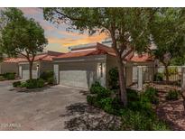 Charming single-story home with a two-car garage, a red tile roof, and well-maintained landscaping at 4225 N 21St St # 22, Phoenix, AZ 85016