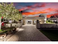 Inviting front of home with manicured landscaping and illuminated walkway at 4835 E Onyx Ave, Paradise Valley, AZ 85253