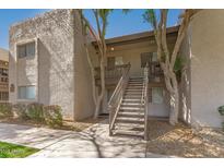 Apartment building exterior with stairs leading to the second floor units under a clear blue sky at 520 N Stapley Dr # 257, Mesa, AZ 85203