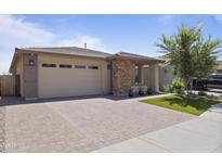 Charming single-Gathering home boasts a large garage and a beautifully paved driveway, creating a welcoming curb appeal at 5871 N 187Th Ln, Litchfield Park, AZ 85340