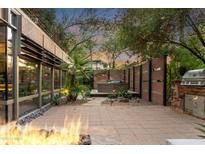 Relaxing patio features a fire pit, built-in grill, and hot tub area perfect for entertaining at 7117 E Rancho Vista Dr # 1012, Scottsdale, AZ 85251