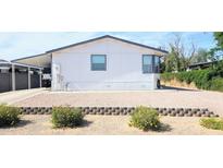 Charming single-story home featuring a carport and low-maintenance landscaping at 8902 E Baltimore St, Mesa, AZ 85207