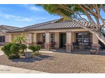 Charming single-story home with a welcoming front porch and desert-style landscaping, creating a warm curb appeal at 9632 E Olla Ave, Mesa, AZ 85212