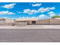Charming single-story home with well-maintained landscaping and a two-car garage at 1055 N 86Th Pl, Scottsdale, AZ 85257