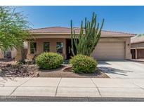 Charming single-story home with well-manicured desert landscaping and a two-car garage at 12417 W Apache St, Avondale, AZ 85323