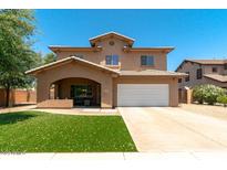 Charming two-story home featuring a well-manicured lawn, inviting porch, and a convenient two-car garage at 1250 E Canyon Creek Dr, Gilbert, AZ 85295