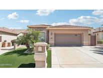 Charming home featuring a two-car garage, desert landscaping, and a welcoming entrance at 16165 W Vale Dr, Goodyear, AZ 85395