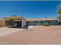 Charming single-story home with a carport and low-maintenance landscaping at 1637 W University Dr, Mesa, AZ 85201