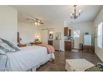 Inviting living space featuring a kitchenette, bed, and a vintage-style refrigerator that offers a cozy and functional area at 1637 W University Dr, Mesa, AZ 85201