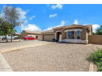 Single-story home with a gravel yard, stone accents, and a two-car garage at 1669 E Santa Fiore St, San Tan Valley, AZ 85140