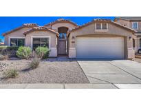 Charming single-story home with desert landscaping, arched entry, and two-car garage at 17617 W Corrine Dr, Surprise, AZ 85388