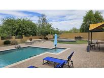 Backyard oasis with a pool, outdoor kitchen, fire pit, and lounge area, perfect for entertaining at 1766 N Channing --, Mesa, AZ 85207
