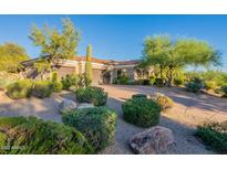 Beautiful desert landscaping enhances this home with a circular driveway and attached garages at 19947 N 94Th Way, Scottsdale, AZ 85255