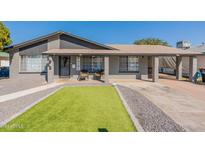 Welcoming front porch with cozy seating, decorative HOME sign, and attractive landscaping at 2022 W Aster Dr, Phoenix, AZ 85029