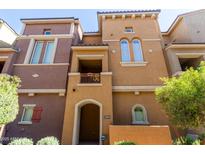 Inviting multi-level townhome showcasing a private balcony and a welcoming arched entryway at 240 W Juniper Ave # 1211, Gilbert, AZ 85233