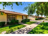 Charming single-story home featuring a well-manicured lawn, tidy landscaping and covered entry on a sunny day at 2442 N 22Nd Ave, Phoenix, AZ 85009
