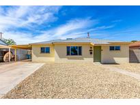 Charming single-story home featuring a gravel yard, neutral paint, and covered parking at 2802 W Butler Dr, Phoenix, AZ 85051