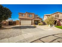 Inviting two-story home features a well-manicured front yard and an attached two-car garage at 33602 N Cobble Stone Dr, San Tan Valley, AZ 85143