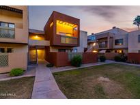 Cozy condo exterior featuring well-maintained lawn and private balcony with decorative lattice at 3500 N Hayden Rd # 710, Scottsdale, AZ 85251