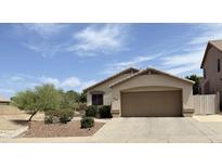 Charming single-story home featuring a two-car garage and a desert-landscaped front yard at 6436 W Saddlehorn Rd, Phoenix, AZ 85083