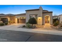 Inviting single-story home featuring a neat front yard, a two-car garage, and an arched entryway at 70 E Kennedia Dr, Queen Creek, AZ 85140