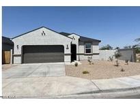 Charming single-story home with a two-car garage and low-maintenance desert landscaping at 91 S Collier Ln, Casa Grande, AZ 85122