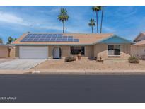 Charming single-story home featuring solar panels and a well-maintained desert landscape at 962 W Keating Ave, Mesa, AZ 85210