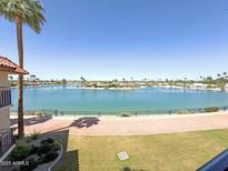 Expansive lake view with waterfront homes and lush landscaping under a clear blue sky at 10330 W Thunderbird Blvd # B313, Sun City, AZ 85351