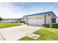 Charming single-story home with attached two-car garage and well-maintained landscaping at 10619 W Loma Blanca Dr, Sun City, AZ 85351