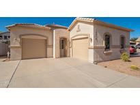 Charming single-story home with dual garages and a well-maintained desert landscape at 15518 W Ocotillo Ln, Surprise, AZ 85374