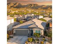 Charming single-Gathering home with a two-car garage and desert landscaping with mountain views at 16551 W Winston Dr, Goodyear, AZ 85338