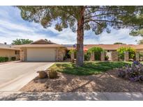 Charming single-story home featuring a well-manicured lawn, desert landscaping, and a spacious two-car garage at 18626 N 130Th Ave, Sun City West, AZ 85375
