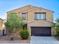 Charming two-story home with desert landscaping and a spacious two-car garage at 19954 W Moonlight Path, Buckeye, AZ 85326