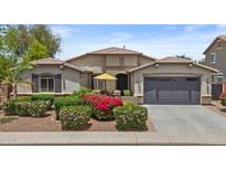 Charming single-story home with desert landscaping, a two-car garage, and a cozy front patio with yellow umbrella at 2466 E Aris Dr, Gilbert, AZ 85298
