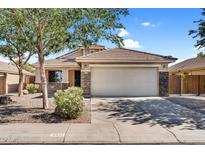 Charming single-Gathering home with a two-car garage, desert landscaping, and stone accents at 2551 W Sawtooth Way, San Tan Valley, AZ 85144
