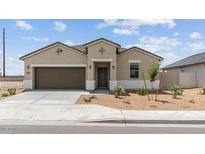 Charming single-story home with a two-car garage and desert landscaping at 38080 W Bello Ln, Maricopa, AZ 85138