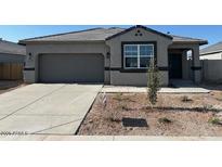 Charming single-story home with a well-maintained yard, spacious driveway, and a two-car garage at 38100 W Bello Ln, Maricopa, AZ 85138