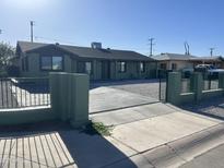 Charming single-story home featuring a landscaped yard and a secure gated entrance at 4602 N 47Th N Ave, Phoenix, AZ 85031