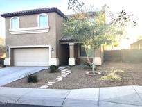 Charming two-story home featuring a well-maintained front yard and attached two-car garage at 4722 S 238Th Ln, Buckeye, AZ 85326